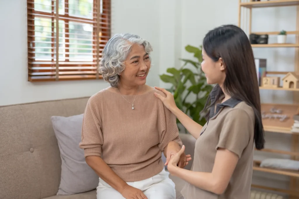 Senior woman sitting with caretaker